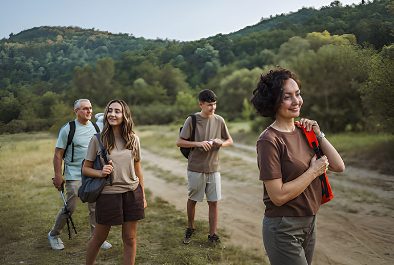 Group of people enjoying an inclusive nature walk through a scenic forest trail.