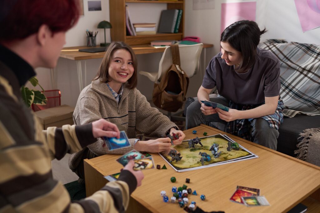 Group of people playing a strategy board game at a table