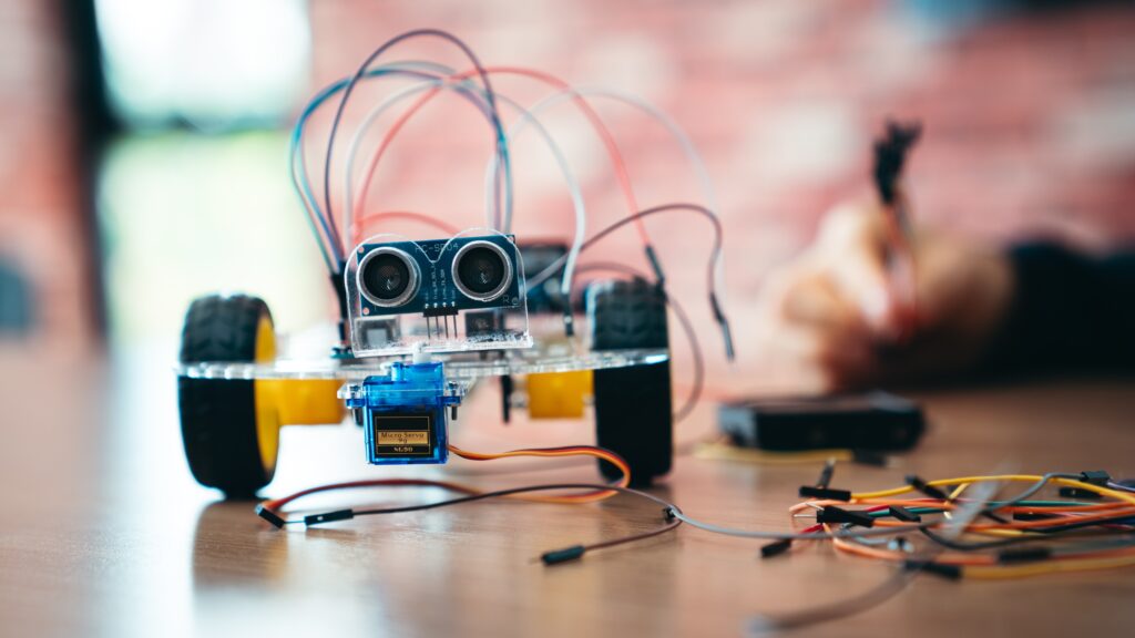 Child assembling a small robot in a STEM learning session